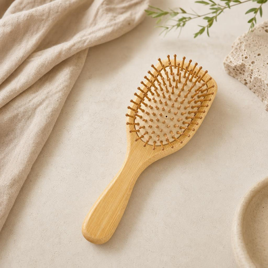 Bamboo paddle hair brush on oat linen