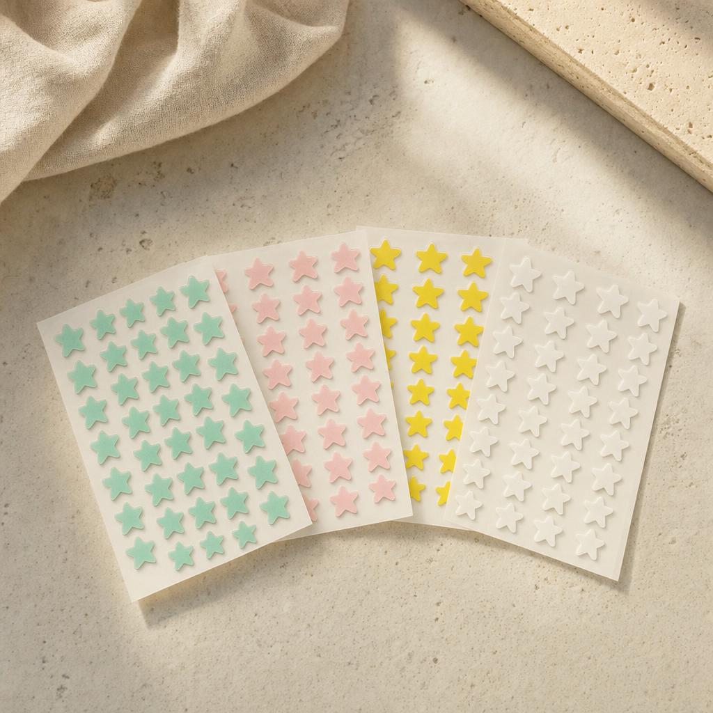 Star-shaped hydrocolloid blemish patches in pastel colors