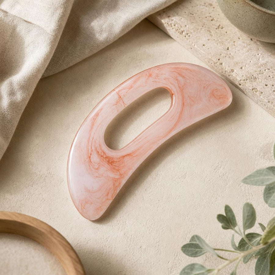 Rose marble gua sha body tool on oat linen