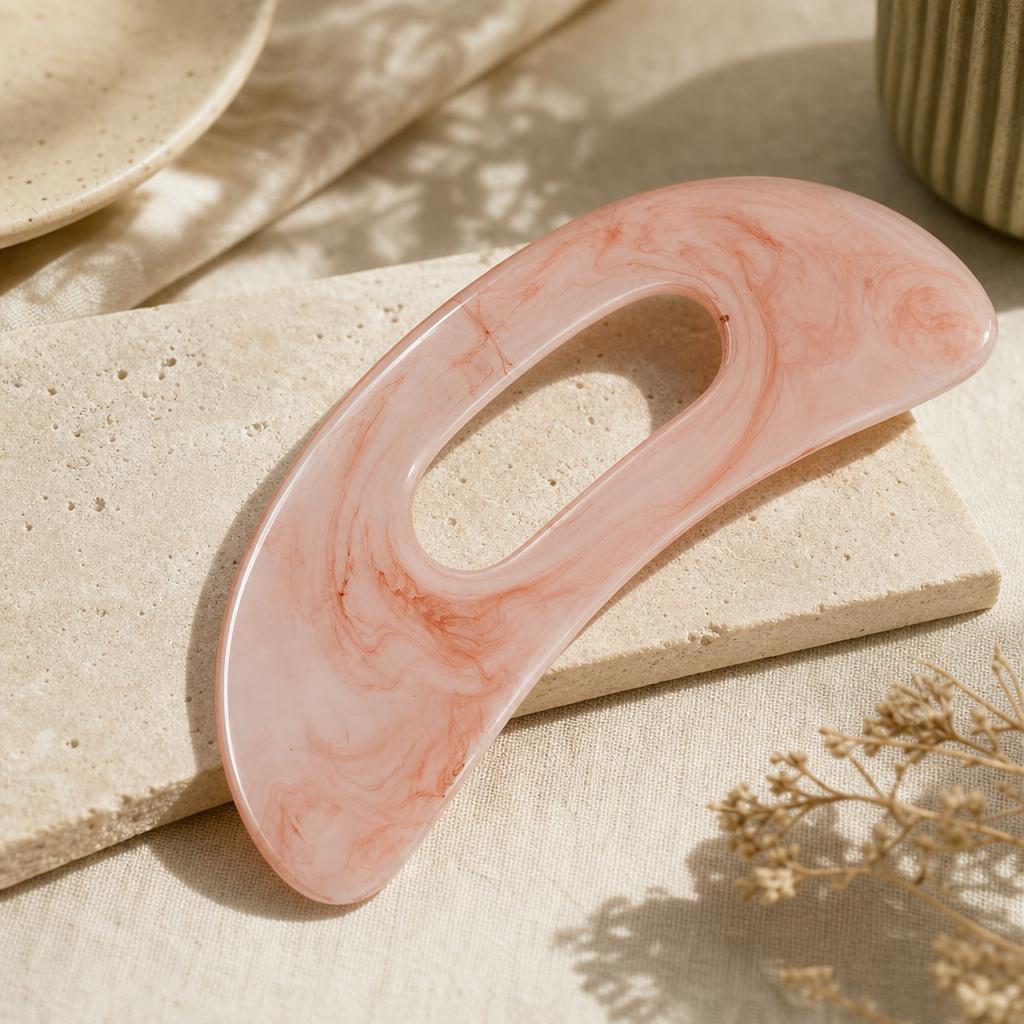 Rose marble gua sha body tool on oat linen