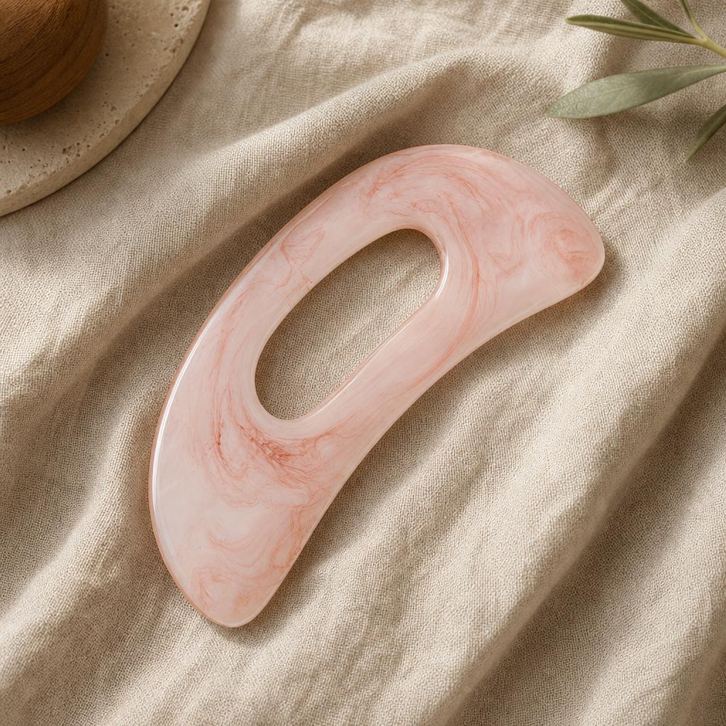 Rose marble gua sha body tool on oat linen